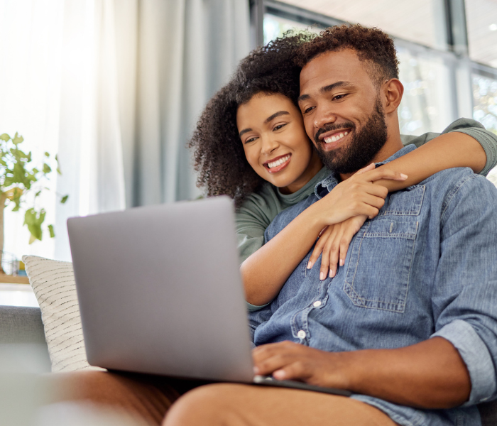 Couple at home signing up for Zenbase. Rent with Minto Apartments.